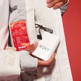 Roxy Women's Dusk Warmlink Insulated Jacket - White jacket with red lining and black zipper on front, held by a woman in white snow pants.