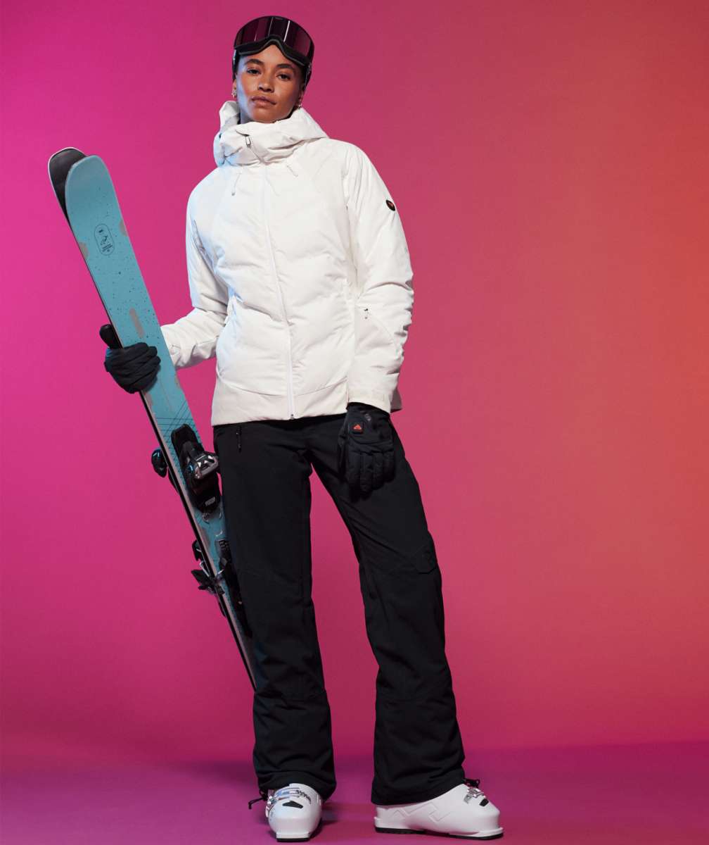 Roxy Women's Dusk Warmlink Insulated Jacket 2024 - A white jacket with a black logo on the left sleeve, worn by a model posing in front of a gray background.