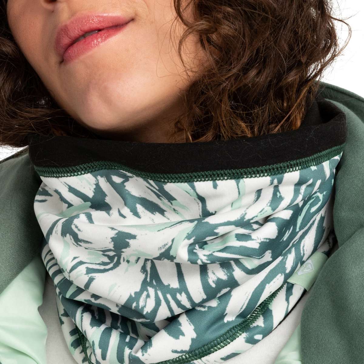 Roxy Women's Lana Collar 2024 - A white scarf with a green abstract brush stroke pattern and dark green trim.