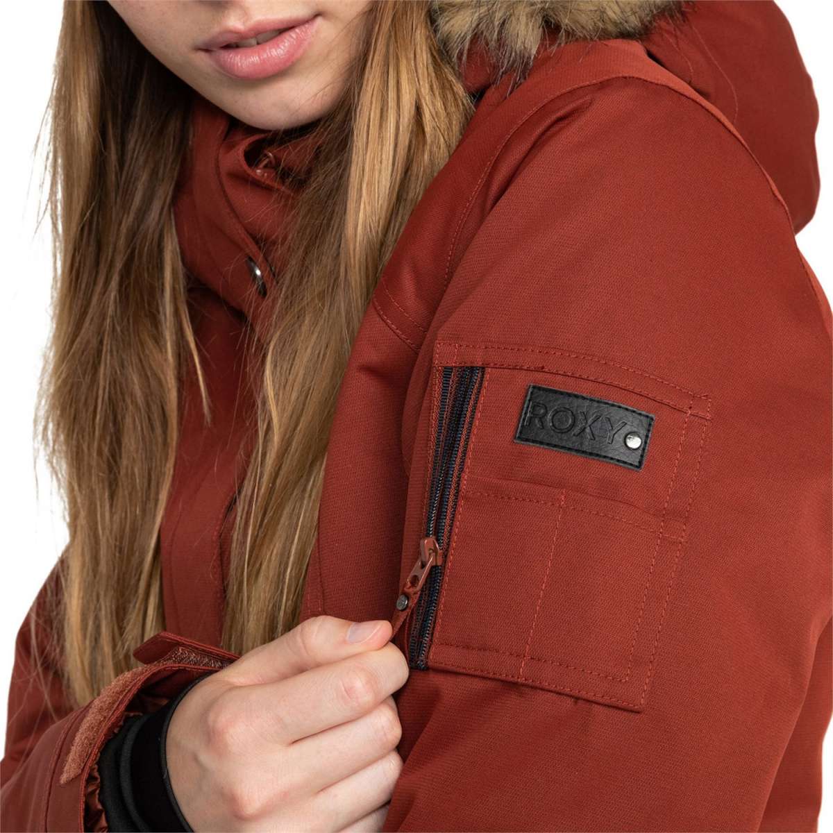 Roxy Women's Meade Insulated Jacket - A rust-colored jacket with a fur-lined hood and zippered pockets.