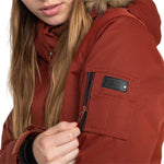 Roxy Women's Meade Insulated Jacket - A rust-colored jacket with a fur-lined hood and zippered pockets.