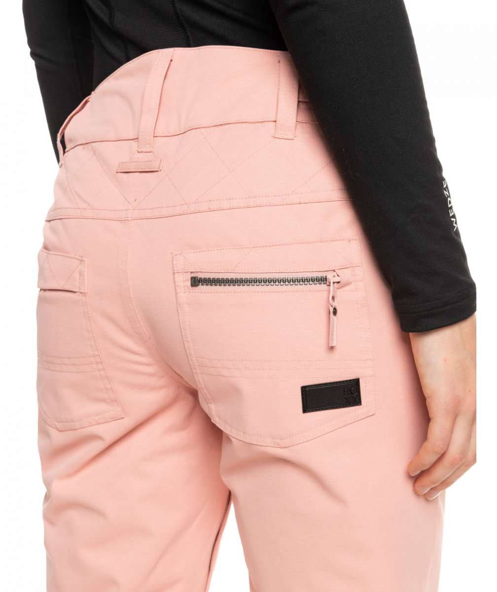 Roxy Women's Nadia Insulated Pant 2023 - A pair of light pink snow pants with a zippered pocket on the back.