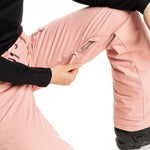 Roxy Women's Nadia Insulated Pant 2023 - A pair of pink snow pants with a zippered pocket on the right thigh and black drawstrings at the waist.