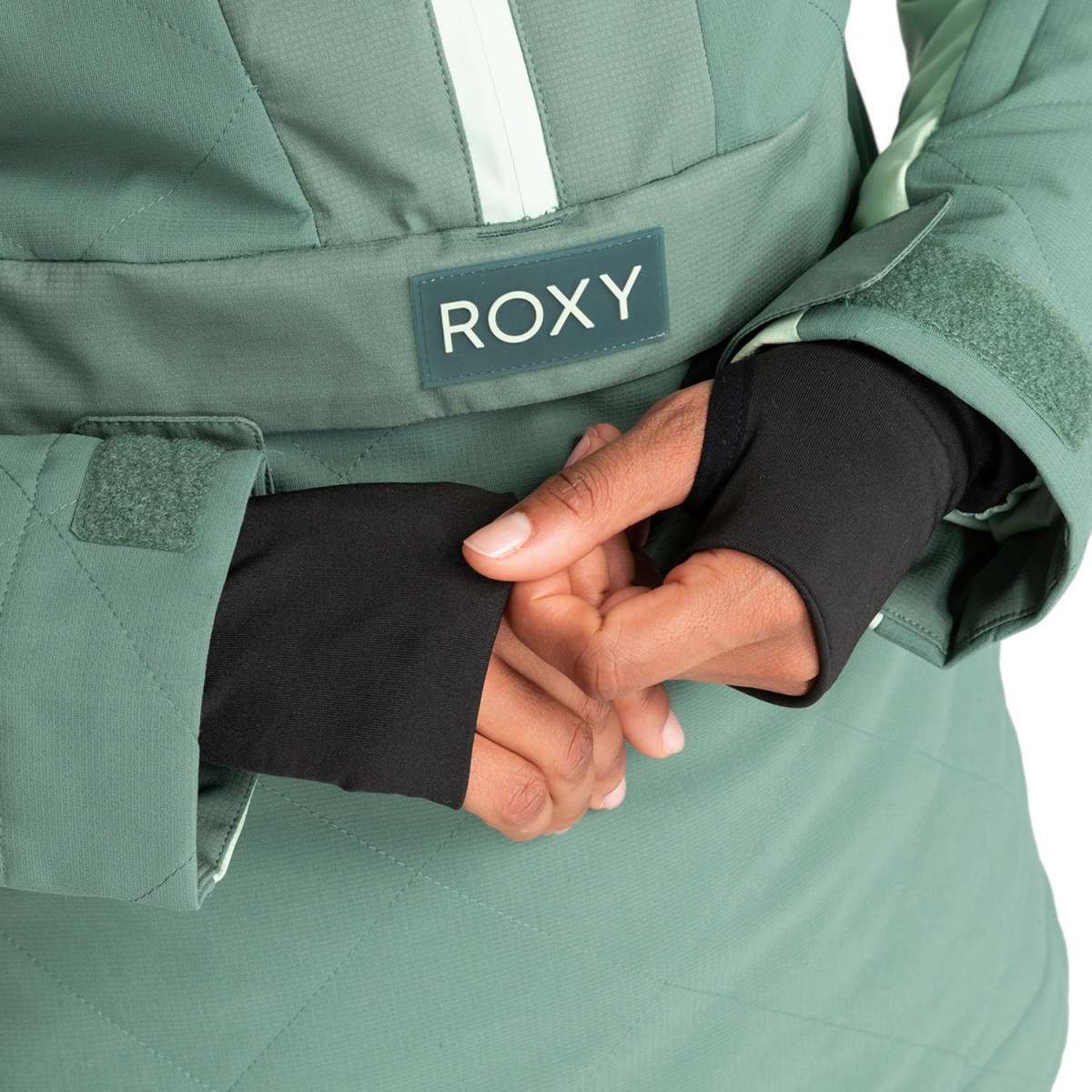 Roxy Women's Radiant Lines Pullover Jacket 2024 - A seafoam green jacket with a white stripe down the center and a zippered chest pocket.