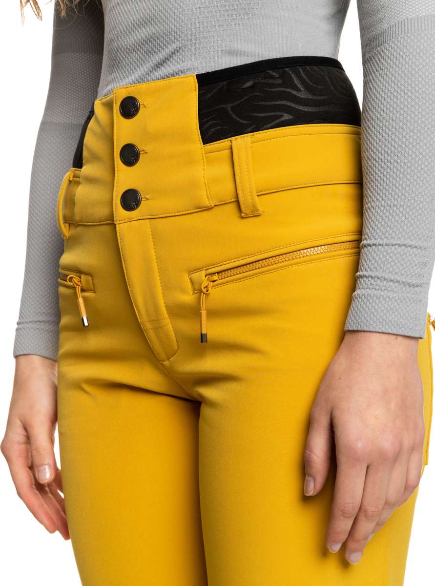 Roxy Women's Rising High Pant 2023 - A pair of yellow ski pants with a black waistband and three black buttons on the left side.