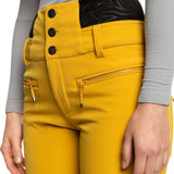 Roxy Women's Rising High Pant 2023 - A pair of yellow ski pants with a black waistband and three black buttons on the left side.