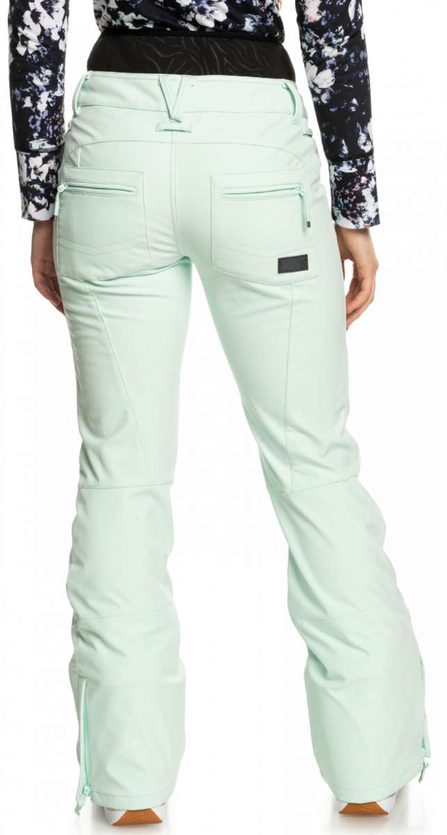 Roxy Women's Rising High Pant 2023 - A pair of light blue snow pants with a subtle floral pattern on the side pockets and a zippered pocket at the back.