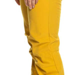 Roxy Women's Rising High Pant 2023 - A pair of yellow ski pants with a black waistband and zipper fly, featuring two zippered pockets on the side.
