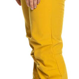 Roxy Women's Rising High Pant 2023 - A pair of yellow ski pants with a black waistband and zipper fly, featuring two zippered pockets on the side.