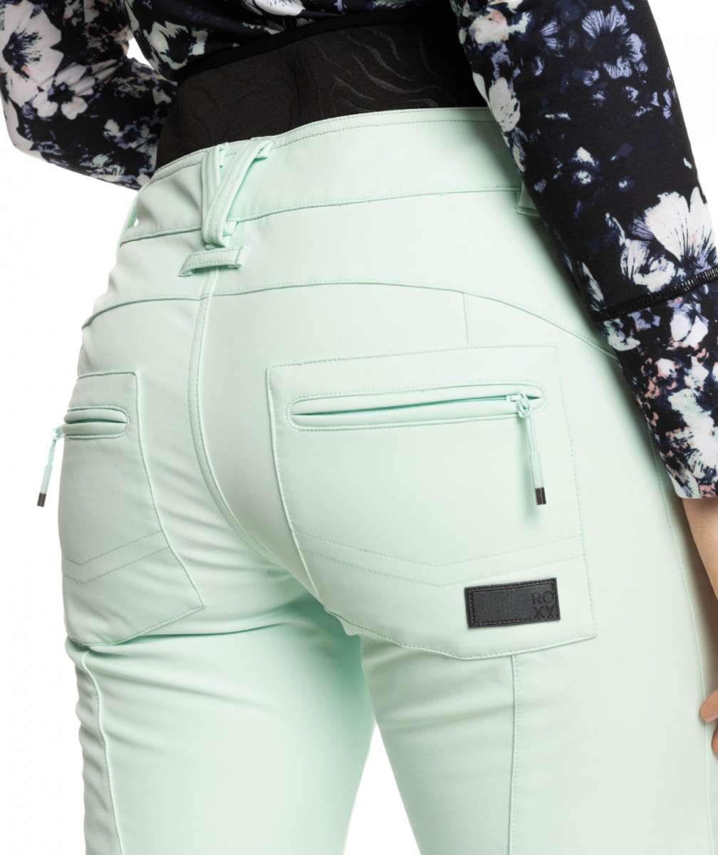 Roxy Women's Rising High Pant 2023 - A pair of light blue pants with a subtle floral pattern on the upper thigh area.
