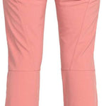 Roxy Women's Rising High Pant 2024 - A pair of pink snow pants with a black waistband and two zippered pockets on the back.