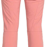 Roxy Women's Rising High Pant 2024 - A pair of pink snow pants with a black waistband and two zippered pockets on the back.