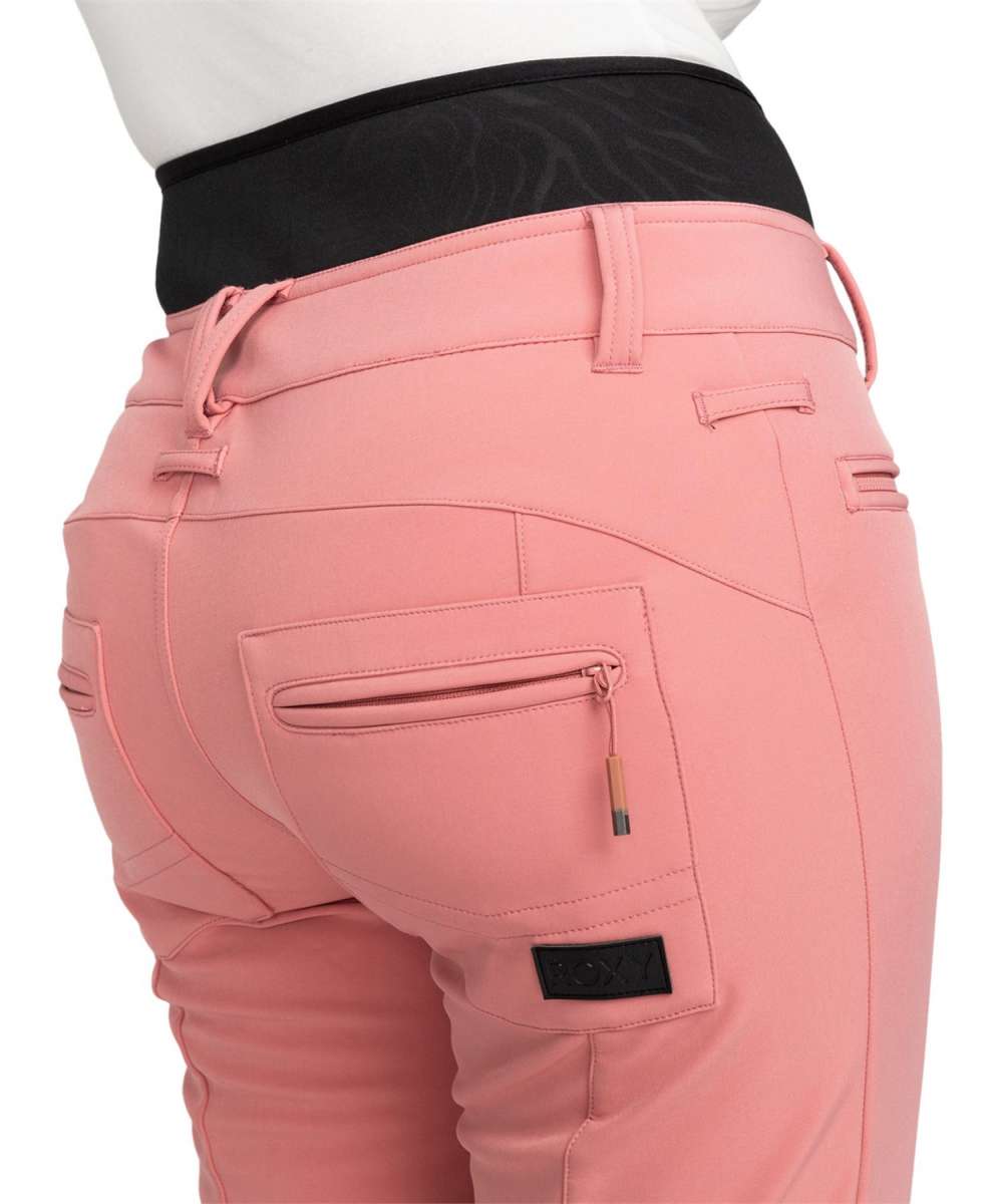 Roxy Women's Rising High Pant 2024 - A pair of pink pants with a subtle floral pattern on the upper thigh area.