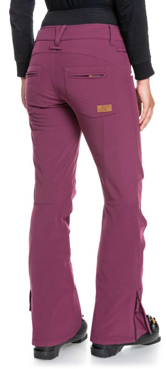 Roxy Women's Rising High Pants 2022 - A pair of women's snow pants with a subtle floral pattern in shades of pink and green on a white background.