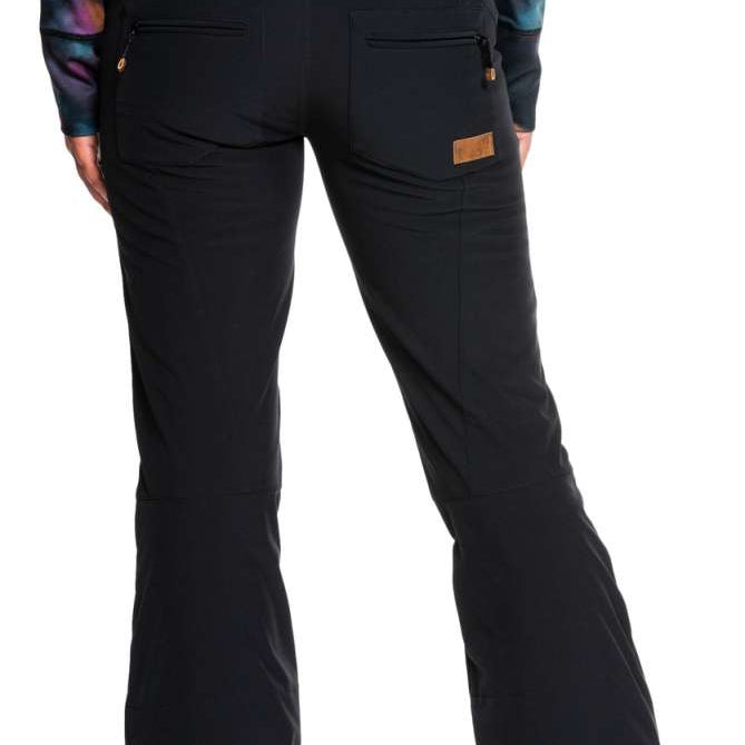 Roxy Women's Rising High Pants 2022 - Black snow pants with zippered pockets and a brown logo patch on the back pocket.