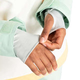 Roxy Women's Shelter Insulated Jacket 2024 - A woman wearing a mint green jacket with yellow stripe down the side, adjusting her wrist cuff.