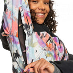 Roxy Women's Stated Insulated Jacket 2023 - A white jacket with a multicolored abstract pattern, featuring black accents and a zippered pocket on the chest.