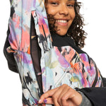 Roxy Women's Stated Insulated Jacket - A white jacket with a multicolored abstract pattern, featuring pink, purple, orange, and black brush strokes.