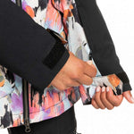 Roxy Women's Stated Insulated Jacket 2023 - A woman wearing a multicolored abstract patterned jacket with black accents and a zipper down the front.