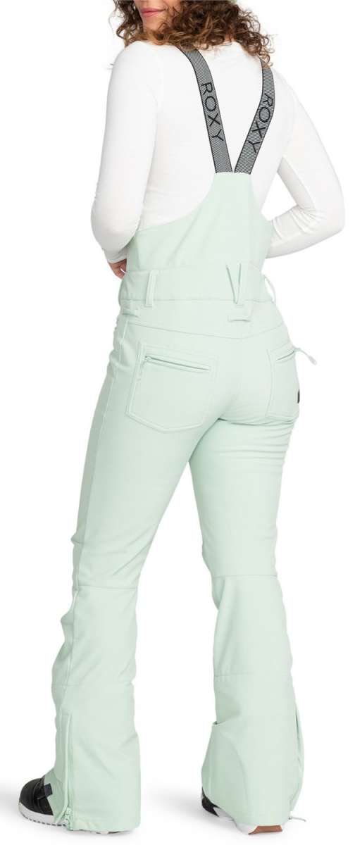 Roxy Women's Summit Bib Shell Pants 2024 - A pair of light blue snow pants with a black logo on the left thigh and a zippered pocket on the right hip.