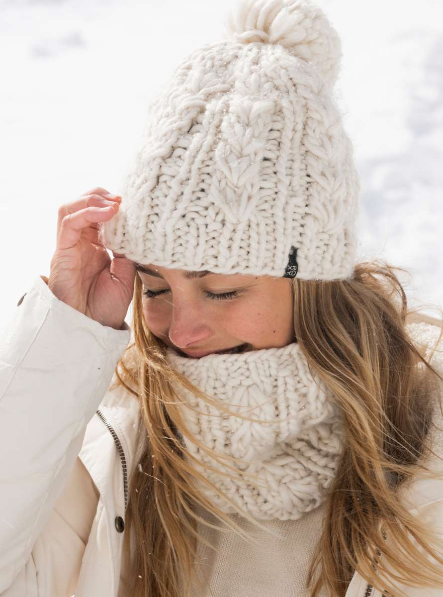 Roxy Women's Winter Beanie 2022 - A cream-colored beanie with a pom-pom on top and a ribbed cuff at the bottom.