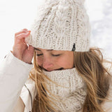 Roxy Women's Winter Beanie 2022 - A cream-colored beanie with a pom-pom on top and a ribbed cuff at the bottom.