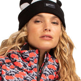 Roxy X Rowley Women's Beanie 2022 - A black beanie with a white stripe on top and a small tag that reads "Rowley" in white letters.