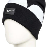 Roxy X Rowley Women's Beanie 2022 - A black beanie with a white stripe around the cuff and a small gray tag on the front that says "ROWLEY XY" in white letters.