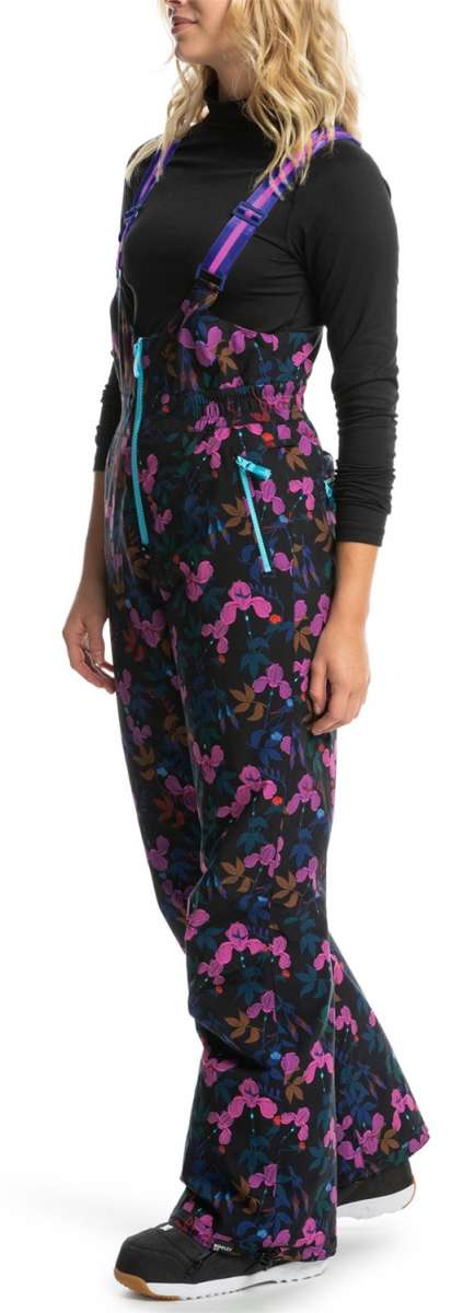 Roxy X Rowley Women's Insulated Bib Pants 2024 - Black bib pants with a floral pattern of pink, blue and brown flowers on a black background.