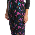 Roxy X Rowley Women's Insulated Bib Pants 2024 - Black bib pants with a floral pattern of pink, blue and brown flowers on a black background.