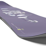 Salomon Women's No Drama Snowboard 2024 - A purple snowboard with a white logo and text on top, featuring a wavy design at the bottom edge.