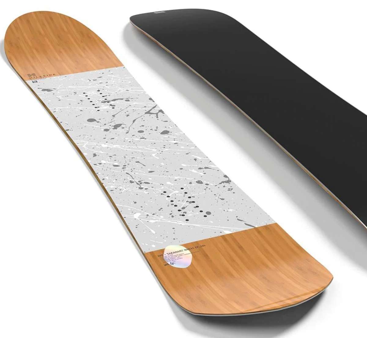 Salomon Takaharu EP Snowboard 2024 - A black snowboard with white and gray splatter design on top of a light-colored wood grain background.