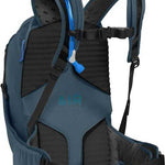 Camelbak Women's Sequoia 24 100 oz Hydration Pack - A blue hydration pack with a zippered front pocket and two mesh side pockets, featuring a water bladder with a blue cap.