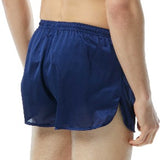 TYR Men's Swim Resistance Short Swimsuit - A pair of men's swim trunks with a solid black color and no visible patterns or designs.