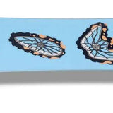 Sims Nub Snowboard 2023 - A light blue snowboard with a black and white logo on top.