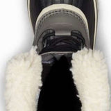 Sorel Ladies Winter Carnival Boot 2022-2023 - A black boot with a white sole and trim, featuring a thick, fluffy white fur lining around the ankle area.