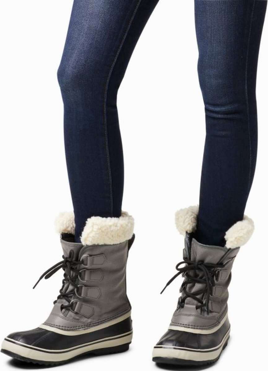 Sorel Ladies Winter Carnival Boot 2022-2023 - A pair of tall, dark brown boots with a thick cream-colored sole and laces.