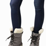Sorel Ladies Winter Carnival Boot 2022-2023 - A pair of tall, dark brown boots with a thick cream-colored sole and laces.
