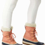 Sorel Ladies Winter Carnival Boot 2022-2023 - A pair of tall, dark brown boots with a thick cream-colored fur lining around the top and a sturdy sole.