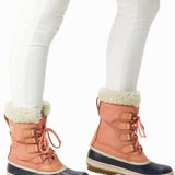 Sorel Ladies Winter Carnival Boot 2022-2023 - A pair of tall, dark brown boots with a thick cream-colored fur lining around the top and a sturdy sole.