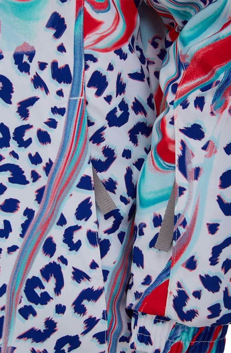 Spyder Girls Lola Insulated Jacket 2022 - A white jacket with a leopard print design in blue and red, featuring gray drawstrings on the hood.