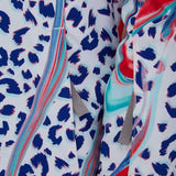Spyder Girls Lola Insulated Jacket 2022 - A white jacket with a leopard print design in blue and red, featuring gray drawstrings on the hood.
