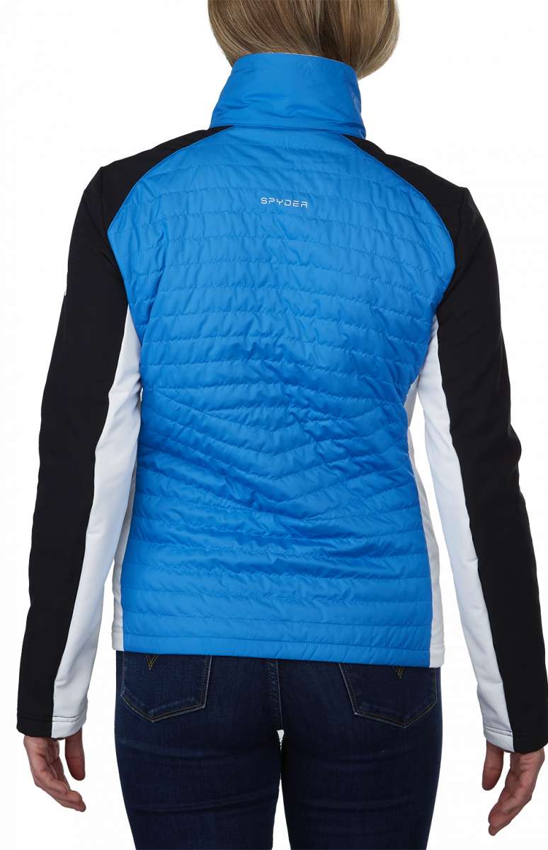 Spyder Ladies Glissade Hybrid Insulated Jacket 2023 - A blue jacket with a high collar and quilted pattern on the back, worn by a model with blonde hair.