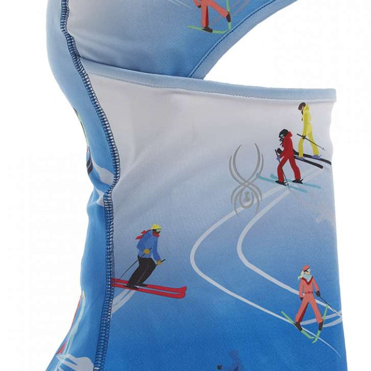 Spyder Ladies Pivot Balaclava 2023 - A light blue balaclava with a repeating pattern of skiers in red, yellow, and black ski suits.