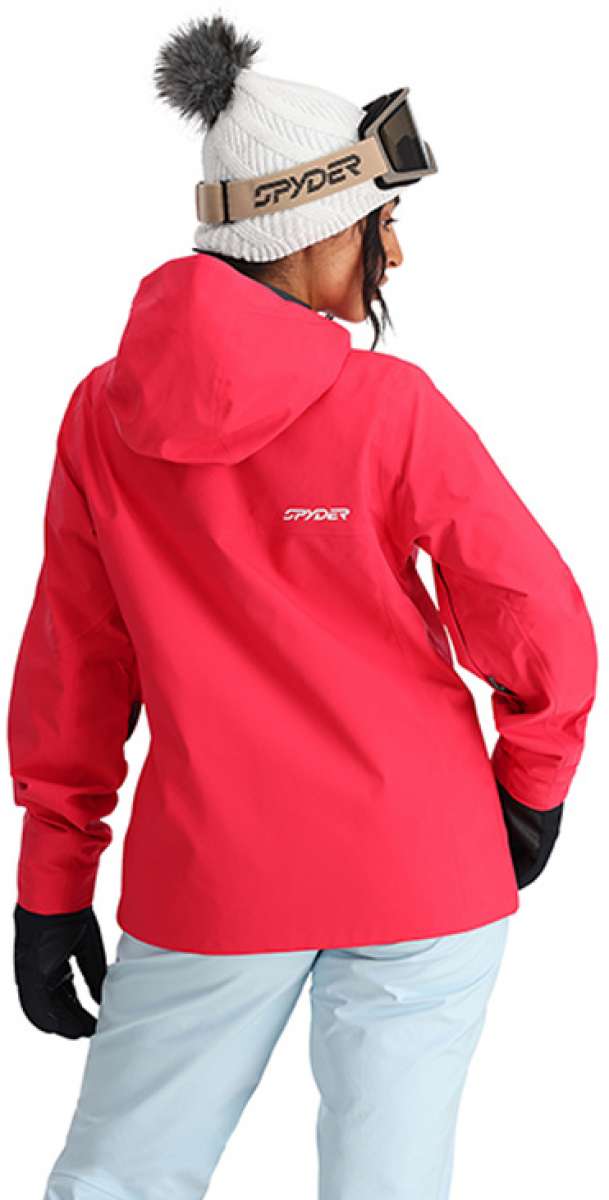 Spyder Ladies Volt GORE-TEX Jacket 2024 - A woman wearing a white knit beanie with gray pom-pom and black gloves, facing away from the camera, showcasing the back of this jacket in red.
