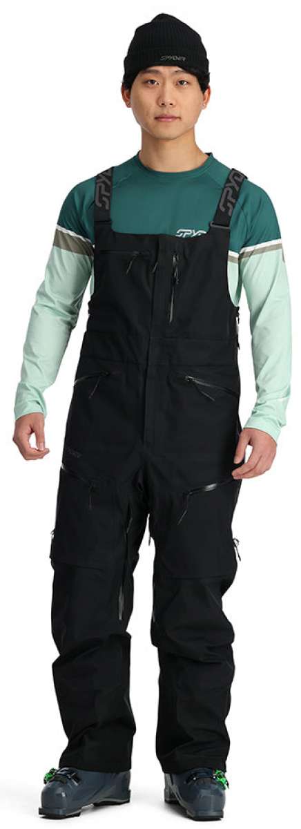 Spyder Sanction GORE-TEX Shell Bib Pants 2024 - Black bib pants with a white logo on the left thigh and black straps over shoulders.