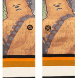 Stance Chewie By Jaz Crew Sock 2024 - A pair of crew socks featuring a large, furry Wookiee character from Star Wars with a brown body and gray bandolier.