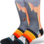 Stance Darth By Jaz Crew Sock 2024 - A pair of crew socks with a silhouette of Darth Vader in black, set against an orange and yellow gradient background.