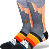 Stance Darth By Jaz Crew Sock 2024 - A pair of crew socks with a silhouette of Darth Vader in black, set against an orange and yellow gradient background.