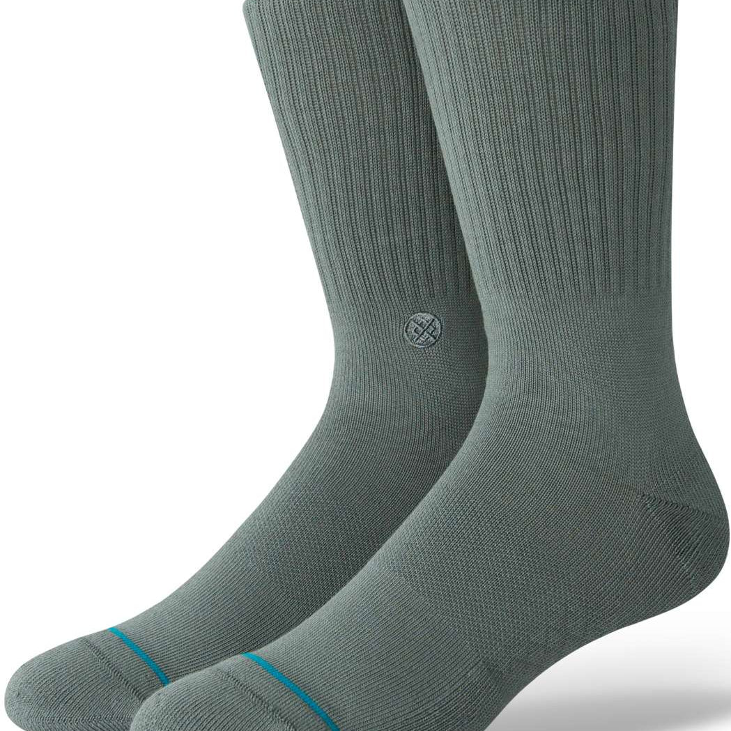 Stance Icon Crew Sock 2024 - A pair of gray crew socks with a small circular logo on the top of one sock's shin area.